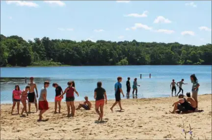  ?? TAWANA ROBERTS – THE NEWS-HERALD ?? Campers enjoy a day at Punderson State Park beach in Newbury Township on June 28.