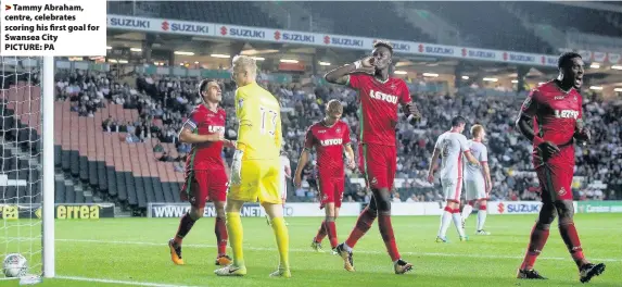  ??  ?? > Tammy Abraham, centre, celebrates scoring his first goal for Swansea City PICTURE: PA