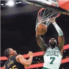  ?? WINSLOW TOWNSON/USA TODAY SPORTS ?? Jaylen Brown scores two of his 32 points on a dunk Tuesday against the Cavs.