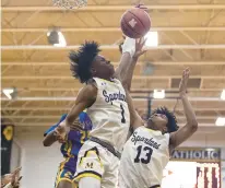  ?? VINCENT D. JOHNSON/DAILY SOUTHTOWN ?? Marian Catholic’s Quentin Jones pulls down a rebound against De La Salle during Thursday’s nonconfere­nce game in Chicago Heights.