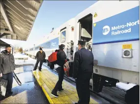  ?? Hearst Connecticu­t Media file photo ?? Riders board a Bridgeport bound train on the Metro North Waterbury branch rail line at the Derby/Shelton station in 2017.