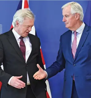  ??  ?? ...and shakes the Brexit Secretary’s hand for the world’s media