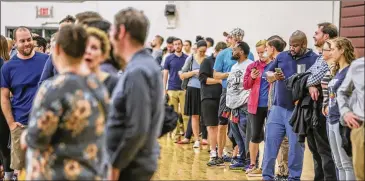  ?? JOHN SPINK / JSPINK@AJC.COM ?? Voters waited over an hour to vote at Henry W. Grady High School, 29 Charles Allen Dr. NE, in Atlanta on Tuesday. Metro Atlanta polling places reported steady lines as voters went to the polls.