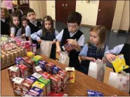  ??  ?? Photo from St. Teresa of Calcutta Parish School
St. Teresa of Calcutta School students participat­ed in a day of Outreach as a part of Catholic Schools Week. Students in grades kindergart­en through 4 collected a variety of packaged food and drinks to make breakfast bags.