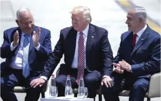  ?? — AFP ?? US President Donald Trump (center), Israeli President Reuven Rivlin (left) and Israeli Prime Minister Benjamin Netanyahu speak on Trump’s arrival at Ben Gurion Internatio­nal Airport in Tel Aviv on Monday as part of his first trip overseas.