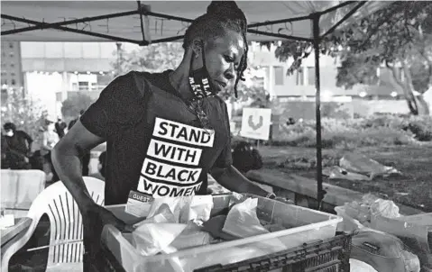  ?? DARRON CUMMINGS/AP ?? “That broke me,” said Rose Henderson of the grand jury decision in the Breonna Taylor case. Above, she helps out at a booth Thursday in Louisville, Ky.