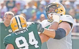  ??  ?? Tackle Bryan Bulaga, right, who’s entering his eighth season, helps anchor Green Bay’s offensive line.