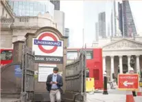  ?? — Reuters ?? A person exits Bank undergroun­d station in the City of London financial district in London.