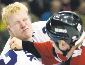  ?? Aaron Harris / Associated Press ?? The Maple Leafs’ Wade Belak, left, fights with the Devils’ Jim McKenzie during a November 2001 game. Belak, Steve Montador, Todd Ewen, Rick Rypien, Bob Probert, Jeff Parker and Derek Boogaard are dead. Many of them were enforcers tasked with delivering and taking punches for teammates, and all took many blows to the head.