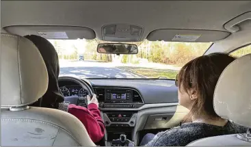  ?? PHOTOS BY SHARON JOHNSON/AP ?? Nancy Gobran, owner of Safety Driving School, instructs one of her students, a 30-year-old Syrian woman who is a refugee, on how to drive a car. Many of the women who enroll in the driving classes come from countries that discourage women from driving or working outside the home.