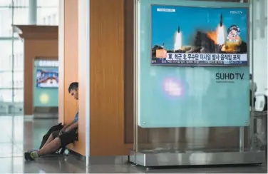  ?? Ed Jones / AFP / Getty Images ?? A television screen shows news coverage of a North Korean rocket launch at the Seoul railway station.