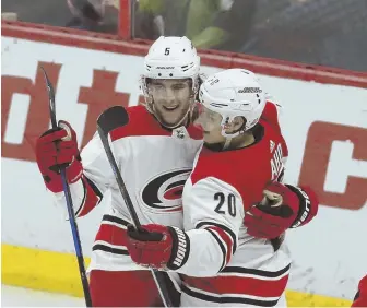  ?? STAFF PHOTO BY CHRIS CHRISTO ?? STORMING AHEAD: Noah Hanifin (5) celebrates with Hurricanes teammate Sebastian Aho after scoring in last night’s 4-1 victory against the Senators.