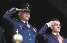  ?? Rebecca Blackwell / Associated Press 2016 ?? Retired Gen. Salvador Cienfuegos ( left) joins former President Enrique Peña Nieto at a military parade in Mexico City in 2016.