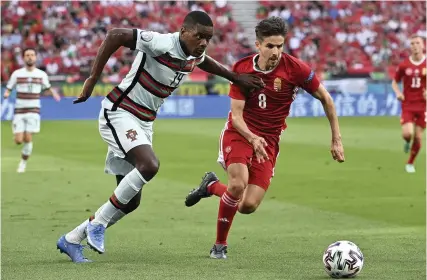  ?? Picture: AP ?? Hungary’s Adam Nagy, right, challenges Portugal’s William Carvalho for the ball