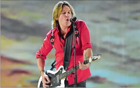  ?? CHRIS PIZZELLO/INVISION/AP ?? Keith Urban performs “Coming Home” at the 53rd annual Academy of Country Music Awards on April 15.