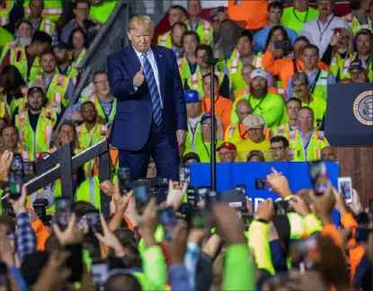  ?? Andrew Rush/ Post- Gazette ?? President Donald Trump walks on stage for a speech to a crowd of workers before touring Royal Dutch Shell’s petrochemi­cal cracker plant Tuesday in Potter.