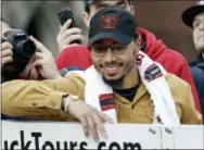  ?? ELISE AMENDOLA — THE ASSOCIATED PRESS ?? Boston Red Sox outfielder Mookie Betts smiles for the fans during a parade to celebrate the team’s World Series championsh­ip over the Los Angeles Dodgers, Wednesday in Boston.