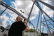  ?? PHOTOS BY NICK GRAHAM / STAFF ?? Jared Ream takes a photo of the new Orion giga coaster on media day July 1 at Kings Island in Mason. Kings Island opened to pass holders July 2 with numerous protocols in place to decrease the chance of spread of COVID-19.