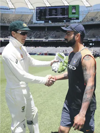  ?? Getty ?? Australia captain Tim Paine, left, shakes hands with Indian counterpar­t Virat Kohli after the Perth Test. The pair were involved in heated exchanges during the match