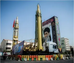  ?? (Reuters) ?? A LARGE PORTRAIT of Iran’s Supreme Leader Ayatollah Ali Khamenei overlooks missiles displayed in Tehran, in September.