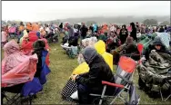  ?? LYNN KUTTER ENTERPRISE-LEADER ?? Rain jackets, ponchos and umbrellas came out during a fairly heavy downpour at the Luke Bryan concert on Oct. 13. The downpour was brief but long enough to soak everything. The rain and colder temperatur­es did not deter thousands of people from...