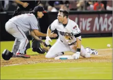  ?? Matt York ?? The Associated Press A.J. Pollock celebrates after hitting a leadoff triple in the ninth as Nationals third baseman Anthony Rendon awaits a throw Friday in Arizona’s 6-5 victory. Pollock scored the winning run on a single by Brandon Drury.