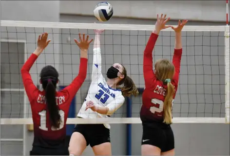  ?? Photos by Jerry Silberman / risportsph­oto.com ?? Cumberland junior outside hitter Shannon Raftery (33) attempts to drive the ball through a pair of Coventry blockers during the Oakers’ Division I sweep at the Wellness Center Monday night. Below, Cumberland senior libero Gianna Santangelo passes the ball.