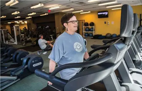  ?? Shiho Fukada / New York Times ?? Linda Guinee, a breast cancer survivor, exercises at a gym in Boston. Scientists are recruiting 3,200 women for a large clinical trial to find out if weight loss should be prescribed as a treatment for breast cancer.