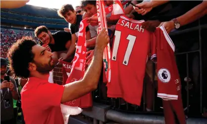  ??  ?? Liverpool’s Mohamed Salah signs autographs for fans during his team’s preseason tour of the USin 2018. Premier League clubs have huge followings in America. Photograph: Jeff Kowalsky/AFP/Getty Images