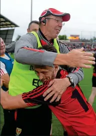  ??  ?? BREAKING THROUGH: Peter Turley forces his way past Monaghan (main) as Down boss Eamonn Burns celebrates with Ryan Johnston