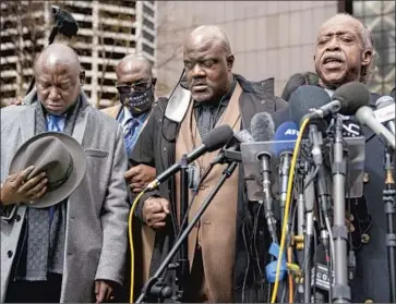  ?? Jason Armond Los Angeles Times ?? LEADING A PRAYER outside the Minneapoli­s court Monday during closing arguments in the Derek Chauvin trial are, from left, attorney Benjamin Crump, George Floyd’s brother Rodney and the Rev. Al Sharpton.