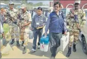  ?? PTI ?? Polling officials carry EVM machines amid a tight security cover in Tripura on Saturday.