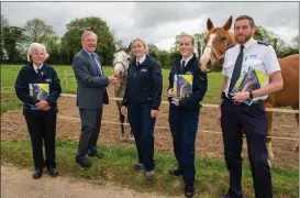  ??  ?? Minister for Agricultur­e, Food and the Marine Michael Creed TD gives a carrot to Samson, a rescued horse, at the ISPCA Mallow Equine Rescue Centre with senior inspector Lisa O’Donovan; Emma Carroll, inspector; Alice Lacey, inspector; chief inspector Conor Dowling and rescued horse Lewis