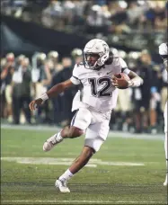  ?? Matthew Maxey / Icon Sportswire via Getty Images ?? UConn QB Tyler Phommachan­h scrambles against Vanderbilt on Saturday in Nashville.