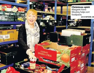  ?? 221216FOOD_05 ?? Christmas spirit Margaret-Anne Moutrey helps sort foodpacks
