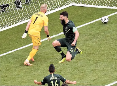  ??  ?? Australia’s Mile Jedinak (center) celebrates after scoring a penalty to make it 1-1 against Denmark during their World Cup Group C match at the Samara Arena in Samara, Russia, yesterday. — AFP