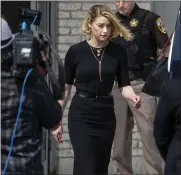  ?? LOS ANGELES TIMES ?? Actress Amber Heard departs the Fairfax County Courthouse on June 1 in Fairfax, Va., after the jury awarded actor Johnny Depp $15 million in his defamation case against her.