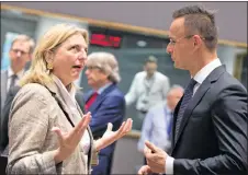  ?? AP PHOTO ?? Austrian Foreign Minister Karin Kneissl, left, speaks with Hungarian Foreign Minister Peter Szijjarto during a meeting of EU foreign ministers at the Europa building in Brussels on Monday. EU foreign ministers on Monday were seeking to protect the bloc’s strategic and economic interests in Iran in the wake of the U.S. withdrawal from the internatio­nal nuclear deal.