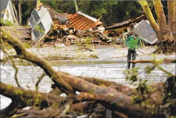  ?? Wally Skalij Los Angeles Times ?? A MAN walks along Olive Mill Road in Montecito in 2018, where mudslides killed 23 people. Such debris f lows are relatively rare in the Santa Cruz Mountains, where f ires rarely burn so widely or with such intensity.