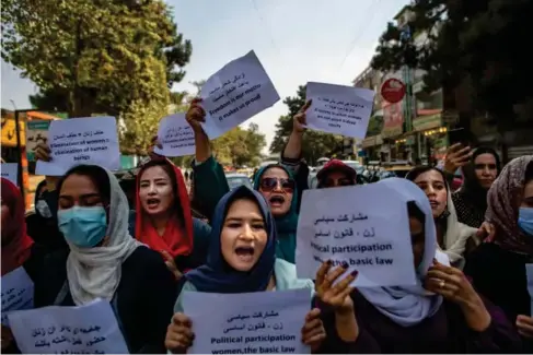  ?? (AFP via Getty) ?? Afghan women hold placards during a demonstrat­ion in front of the former Ministry of Women’s Affairs in Kabul