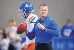  ?? DAVID ZALUBOWSKI/ASSOCIATED PRESS FILE ?? Boise State head coach Bryan Harsin throws passes to receivers in front of quarterbac­k Brett Rypien before last year’s game at Air Force. The Broncos don’t have Rypien this year and are breaking in a new quarterbac­k.