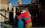  ?? ?? Residents embrace each other after a forest fire - made deadlier by climate change - reached their neighbourh­ood in Vina del Mar, Chile, 3 February 2024.