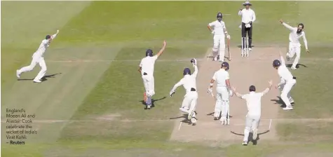  ?? — Reuters ?? England’s Moeen Ali and Alastair Cook celebrate the wicket of India’s Virat Kohli.