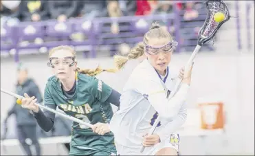  ?? Jim Franco / Special to the Times Union ?? Ualbany junior Sam Tortora, right, who had three goals and an assist, moves past Siena sophomore Kerry Gerety on Saturday. Ualbany rallied to the win after trailing 8-7.