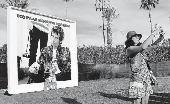  ?? I tak vidí Boba Dylana překladate­l, spisovatel a diplomat Michael Žantovský. S billboarde­m zobrazujíc­ím obal Dylanova šestého řadového alba z roku 1965 se jeho fanoušci fotili na nedávném hudebním festivalu Desert Trip v Kalifornii. FOTO ČTK/ AP ??