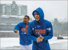  ?? BRIAN CASSELLA — CHICAGO TRIBUNE VIA AP ?? Cubs second baseman Javier Baez, front, plays in the snow at Wrigley Field in Chicago, Monday. The Cubs baseball game against the Pittsburgh Pirates was postponed a day because of snow that covered much of Wrigley Field, creating a scene more...