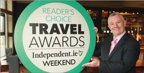  ??  ?? Eibhear Coyle, general manager of the Amber Springs Hotel, with the Irish Independen­t Reader Travel Award after being named in the top 10 Irish Hotels.