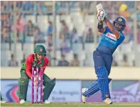  ?? AFP ?? sri lanka’s kusal Perera is bowled as Bangladesh wicketkeep­er mushfiqur Rahim looks on in their tri-series match. —