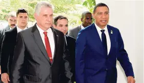  ?? LIONEL ROOKWOOD/PHOTOGRAPH­ER ?? Cuban President Miguel Diaz-Canel (left) and Prime Minister Andrew Holness arrive at a special luncheon held at The Half Moon Golf Course in Montego Bay on Thursday as part of the 39th Regular Meeting of CARICOM Heads of Government held in Montego Bay...