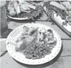  ?? PAUL A. SMITH / MILWAUKEE JOURNAL SENTINEL ?? A shore lunch included fresh walleye fillets, baked beans and fried potatoes on Whitewater Lake.